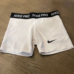 Girls white Nike pros.